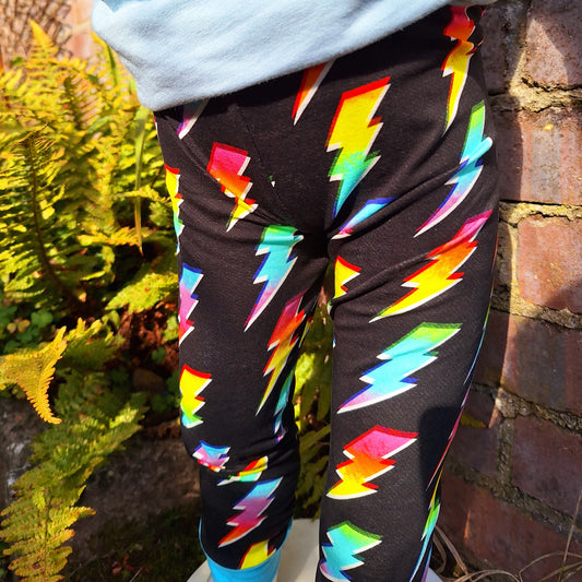 Funky kids leggings, on a Black childrens leggings with rainbow lightning bolts