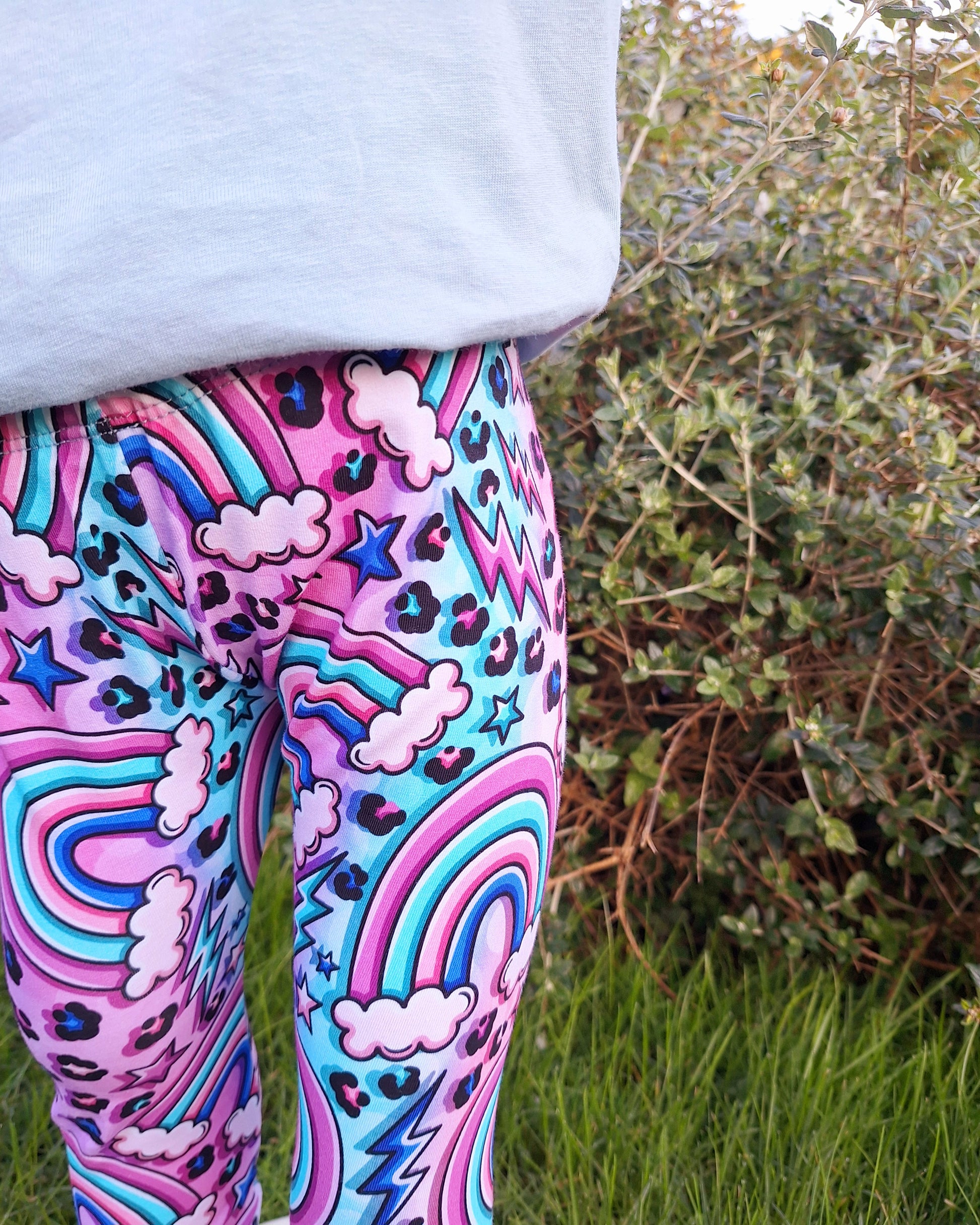 Childrens leggings in a pink fabric featuring hearts, lightning bolts and leopard print