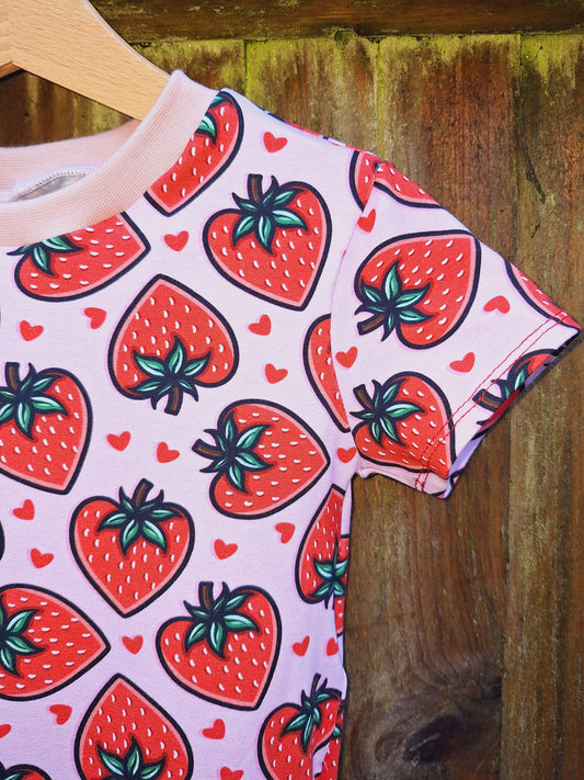 Pink dress with red heart shaped strawberries