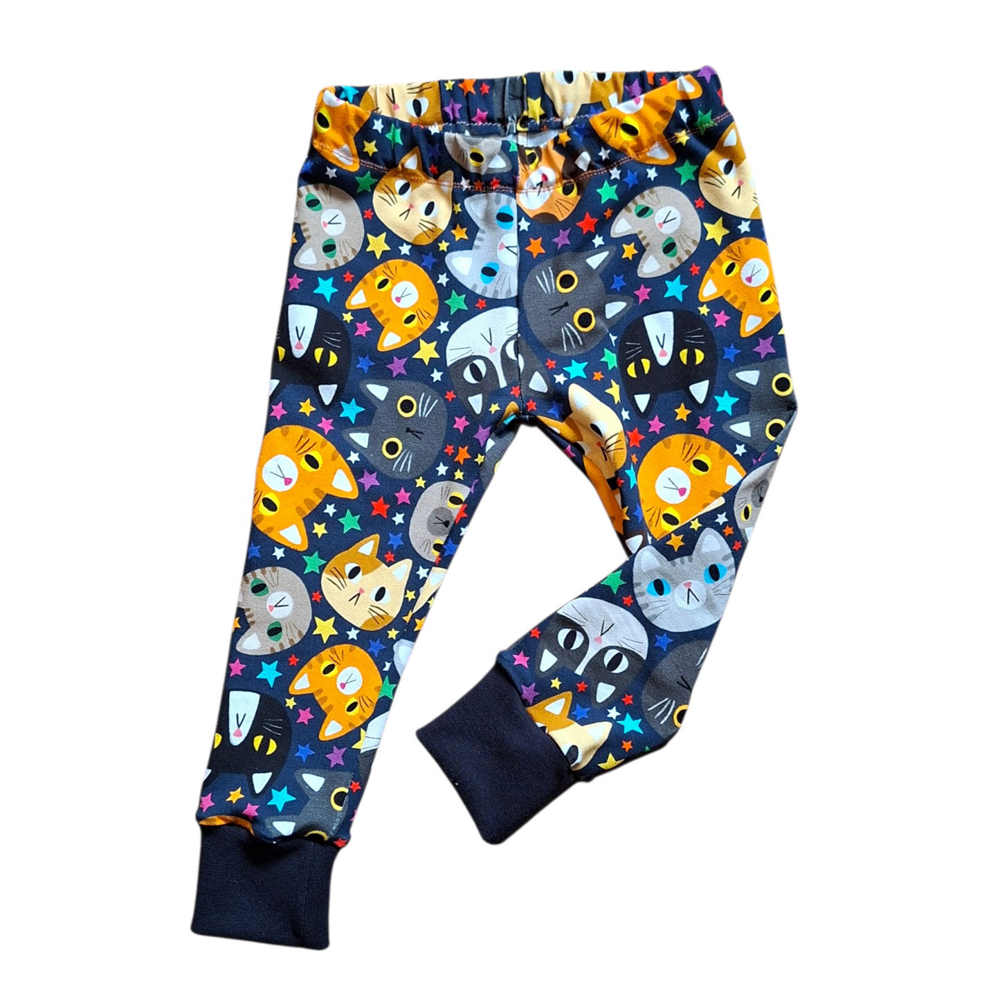 Colorful children's pants with cat pattern on a white background