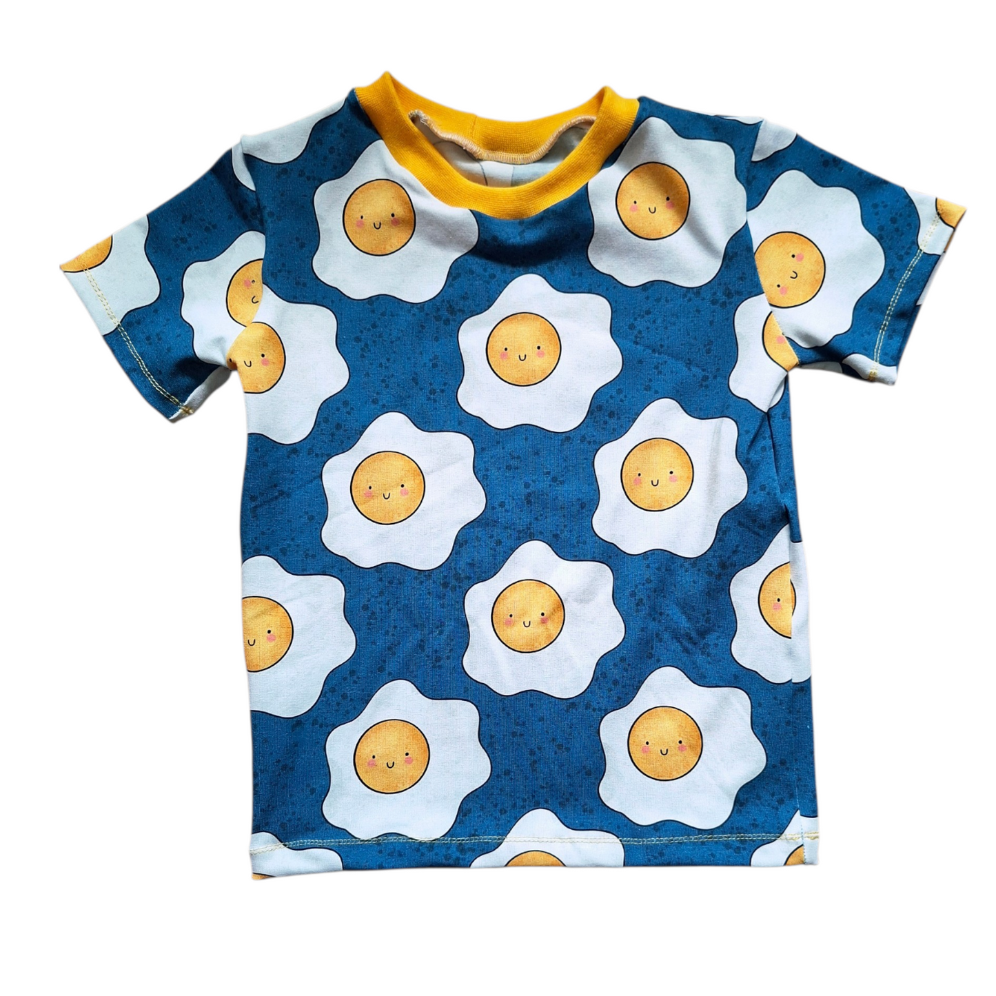 Children's t-shirt with sunny-side up egg pattern on a blue background