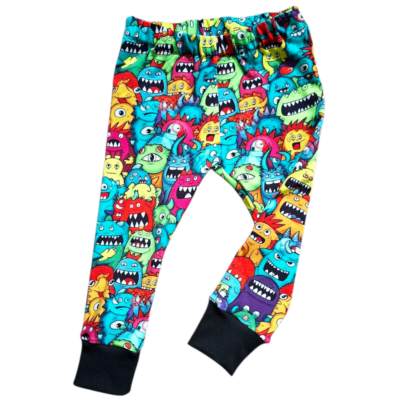 Colorful children's leggings with cartoon monster pattern on a white background