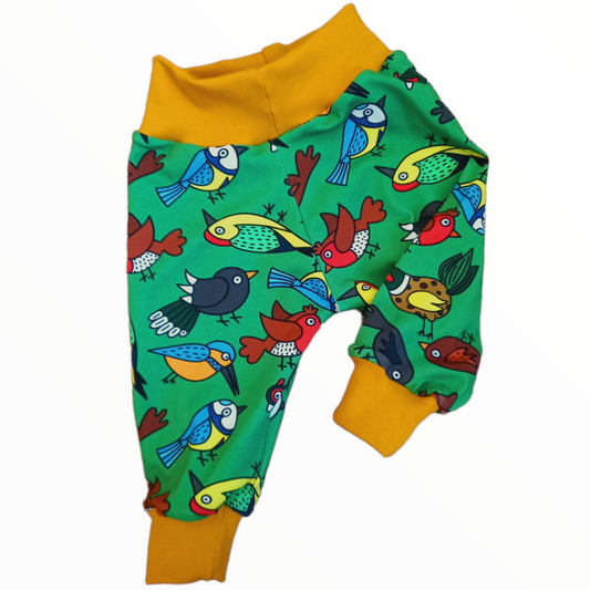 Cloth nappy friendly childrens trousers in a nature design on a green fabric with British garden birds