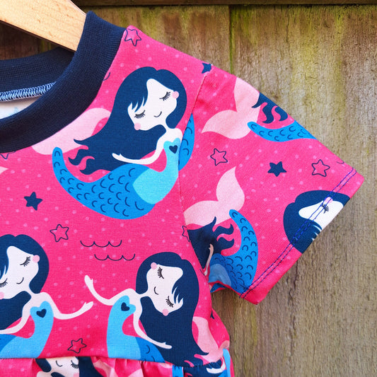 Pink child's dress with mermaids