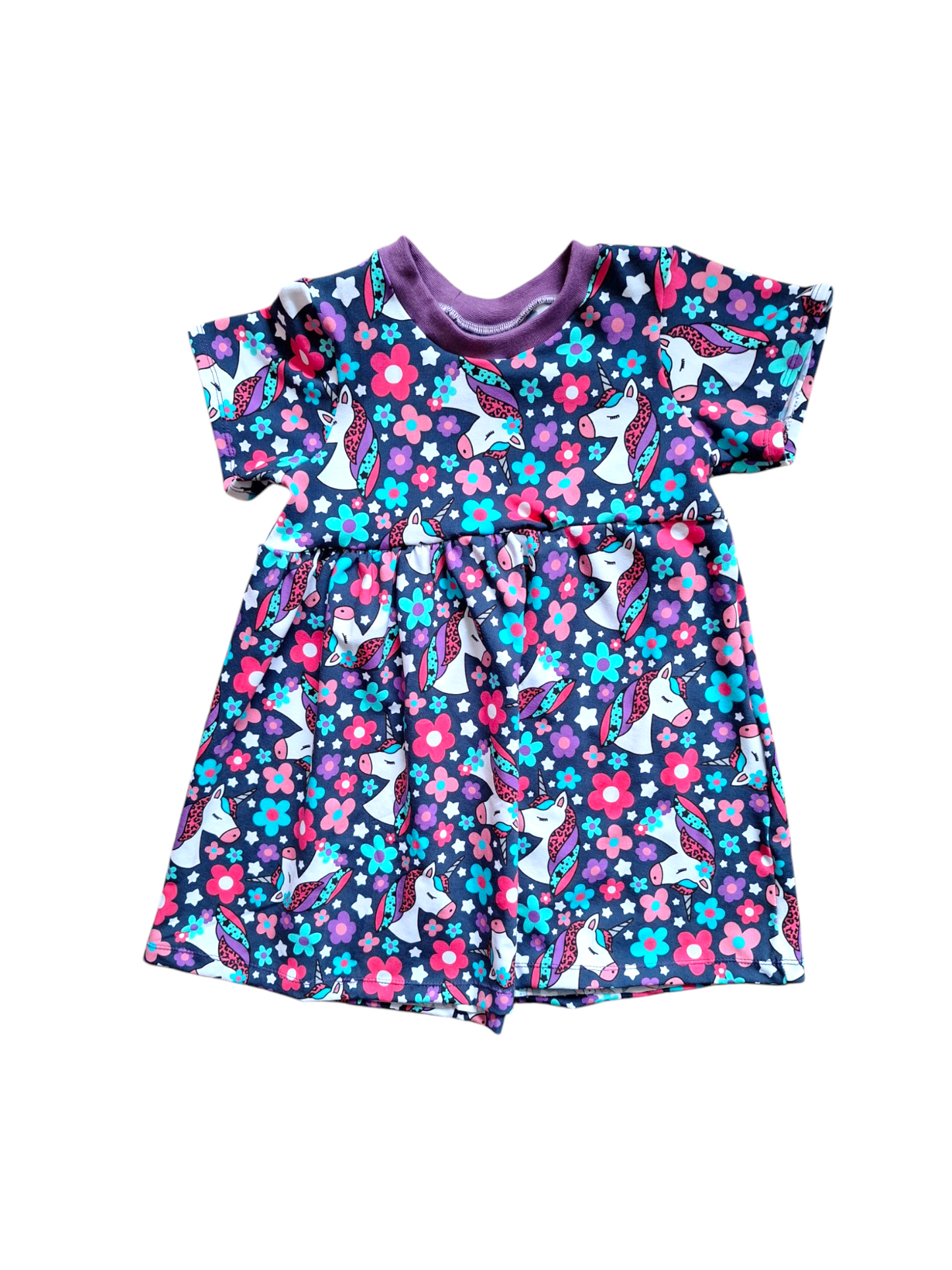 Navy blue child's dress with pink and purple unicorn pattern