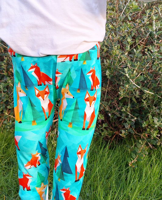 Green childrens leggings with red and orange foxes. Fox print childrens leggings 