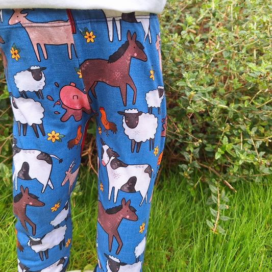 Blue childrens leggings with a mix of farm animals. 