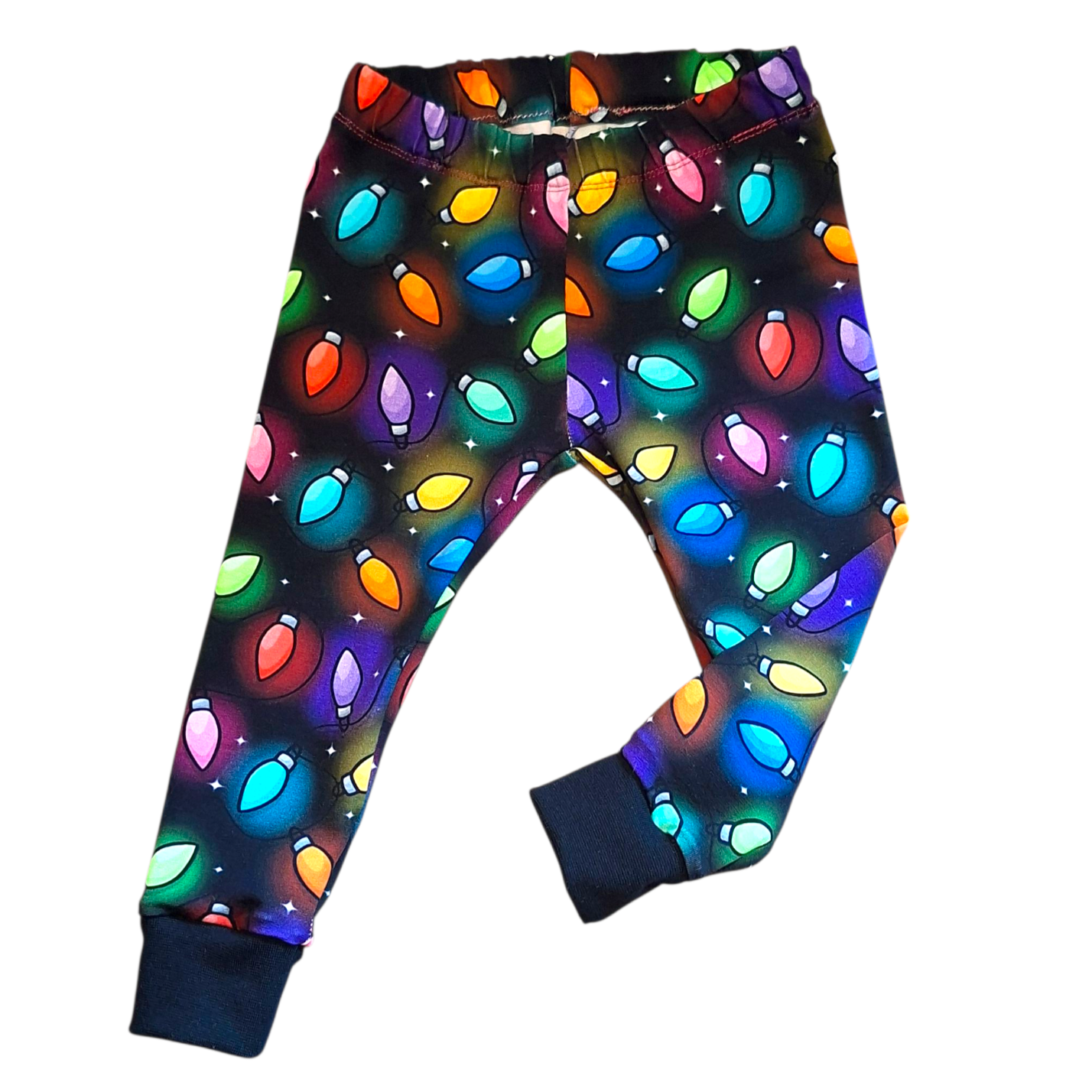 Christmas lights patterned pants with a black background