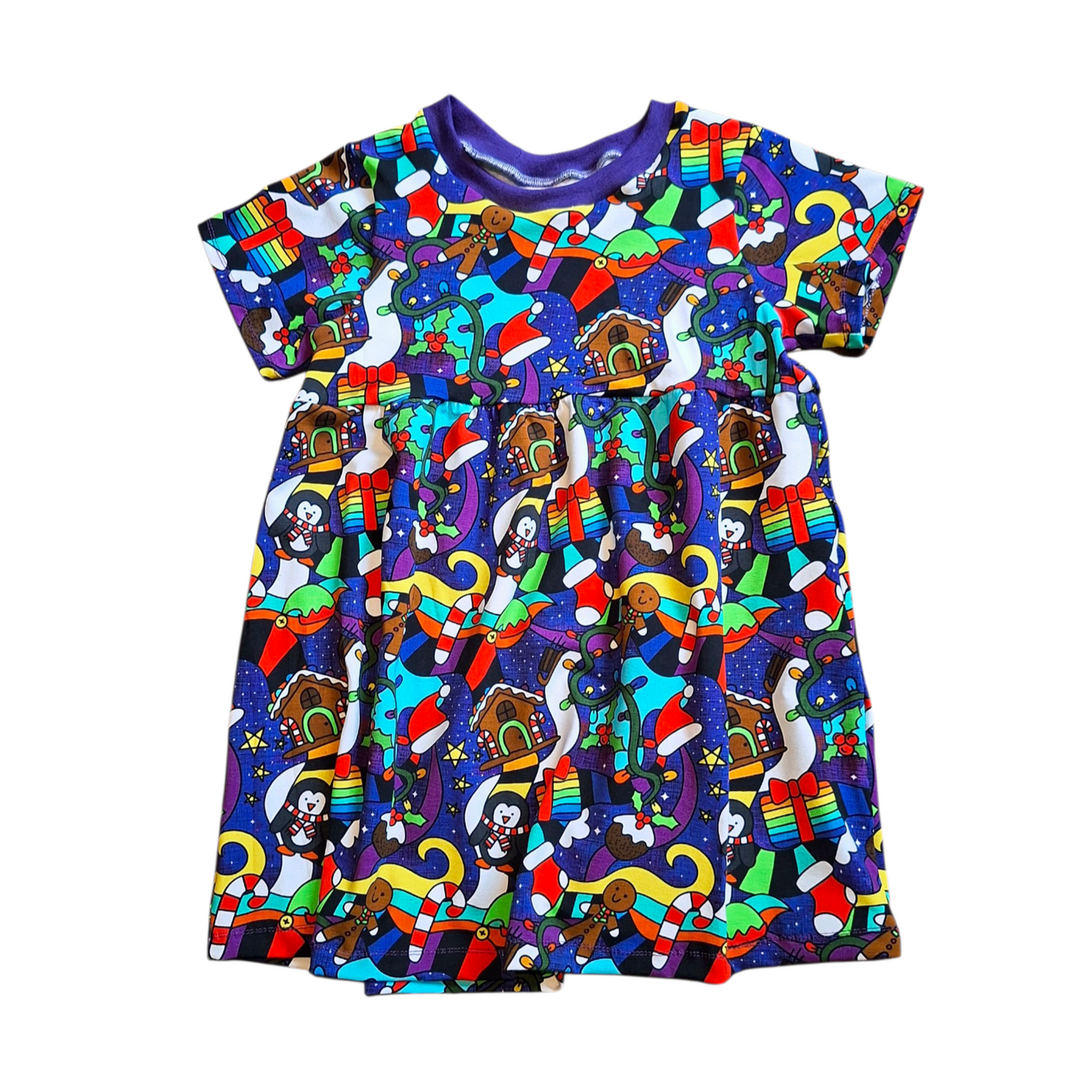 Colorful children's dress with a pattern of christmas cartoon characters on a white background