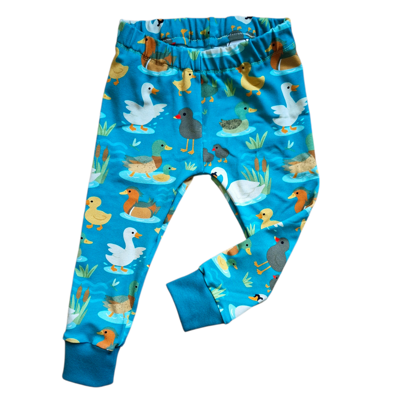 Children's pajama pants with duck and goose pattern on a blue background