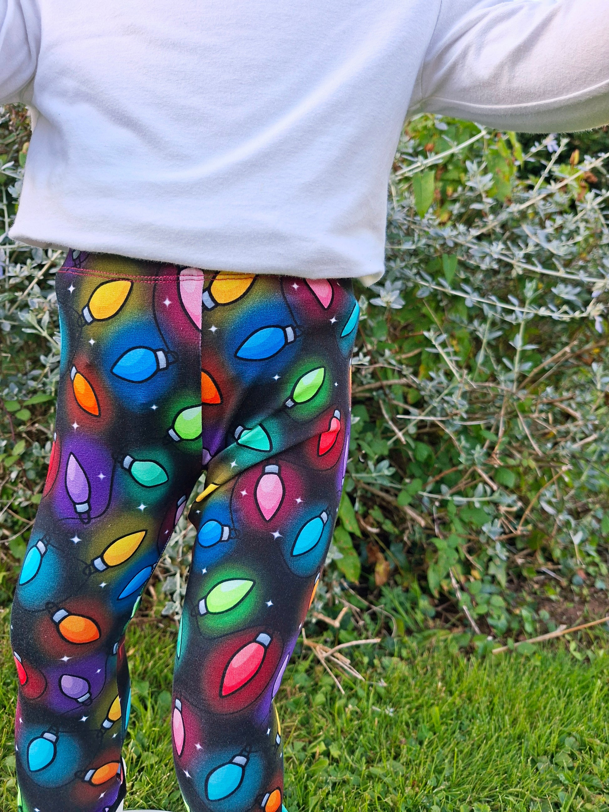 Colorful patterned leggings worn by a person outdoors.