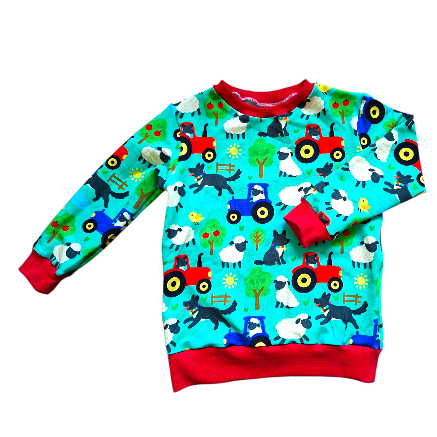Children's sweater with farm animal and tractor pattern on a white background