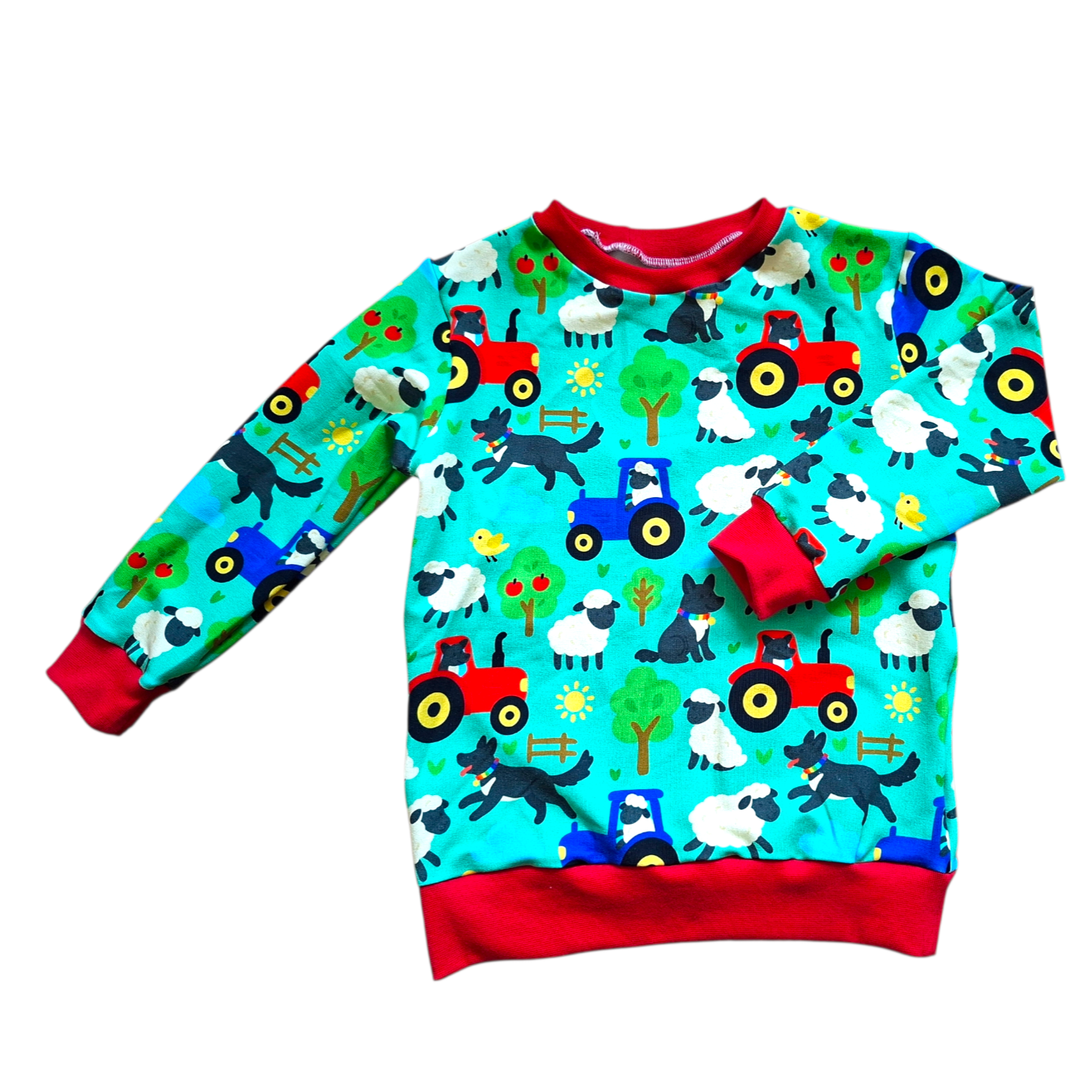 Children's sweater with farm animal and tractor pattern on a white background