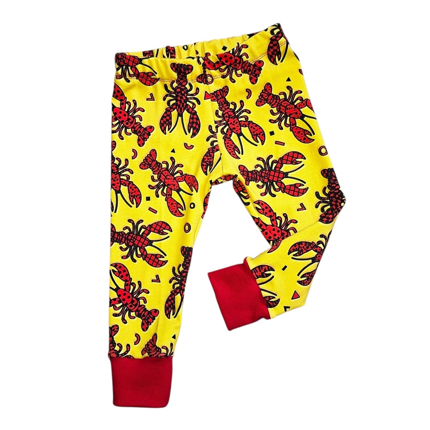 Yellow pants with red lobster pattern on a white background
