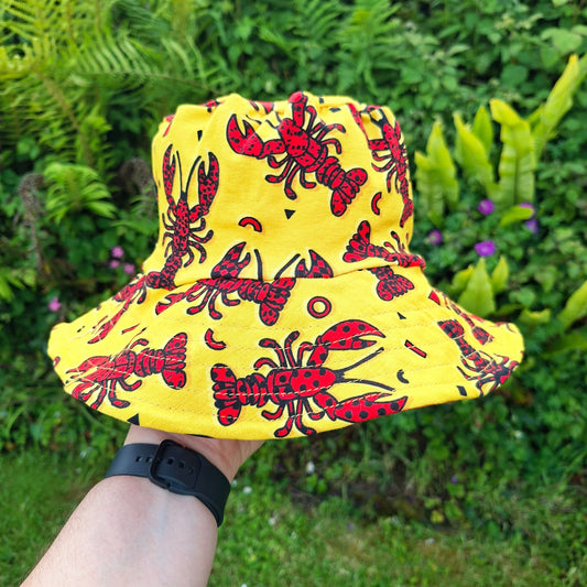 Yellow hat with red lobsters on a bucket style sun hat 