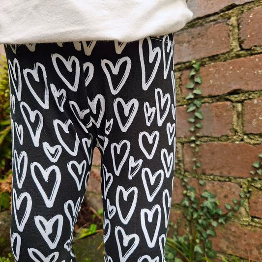 Black and white children's leggings featuring a heart design 