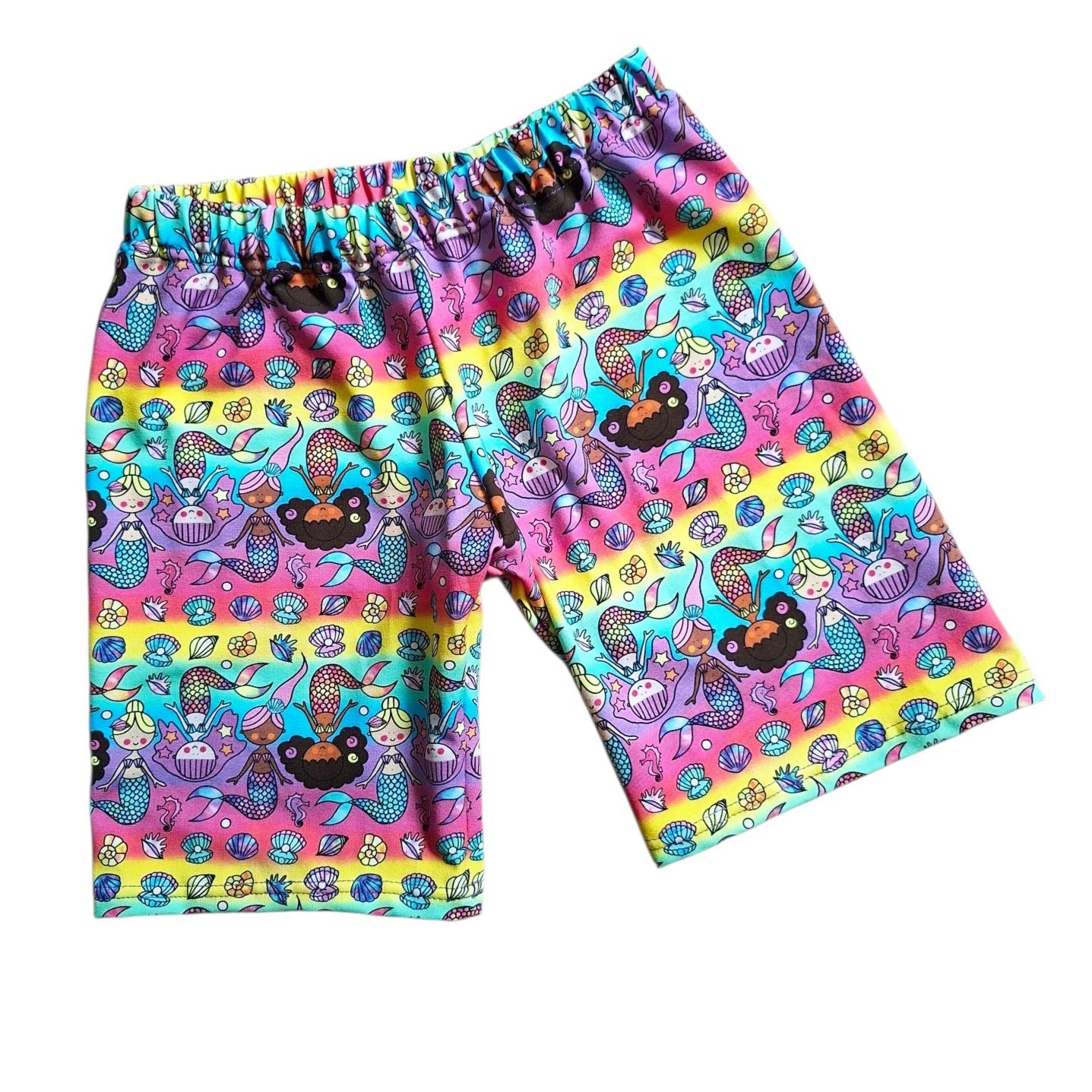 Colourful shorts with mermaid and sea-themed pattern on a white background