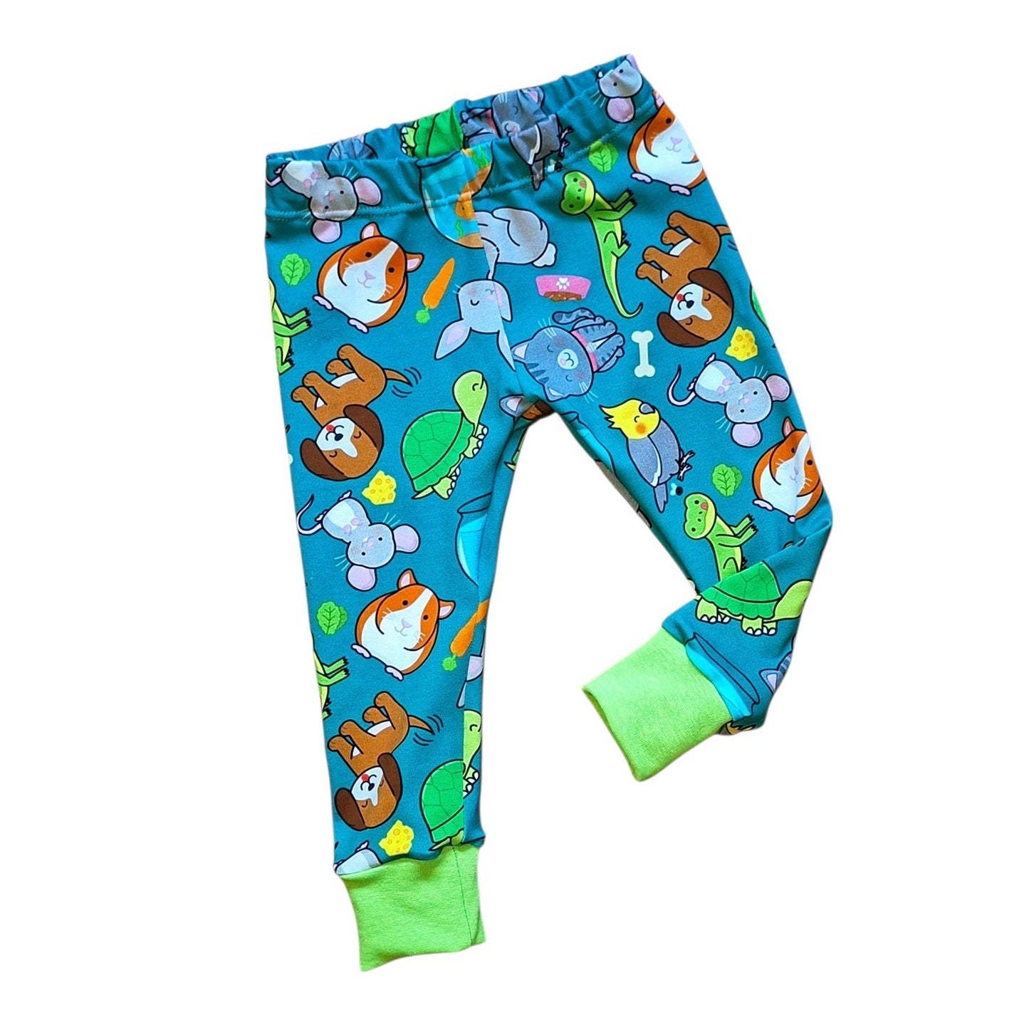 Blue children's leggings with an all-over cartoon animal print and bright green ribbed cuffs, shown on a plain white background.