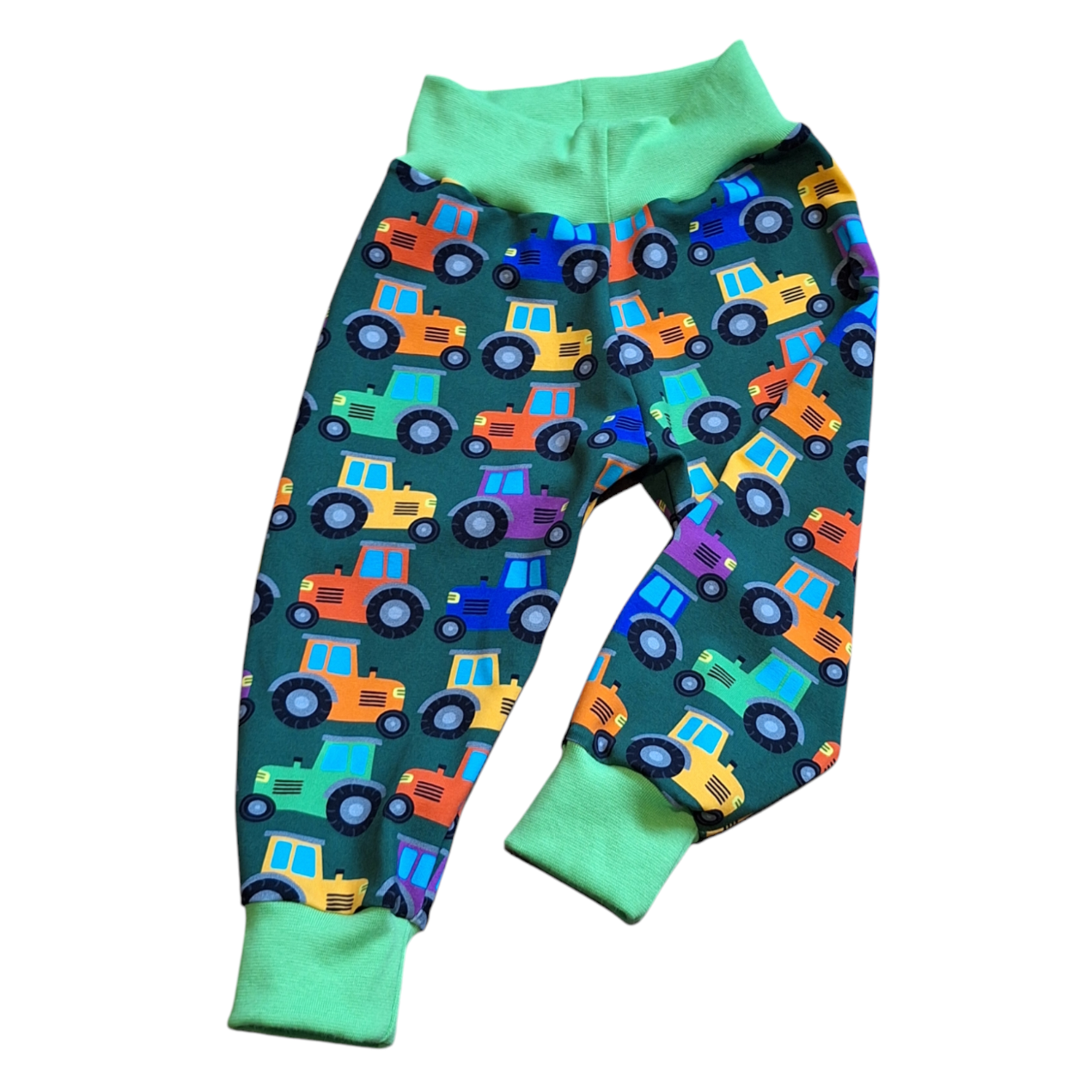 Parsnip pants style childrens trousers that fit over cloth nappies,  featuring rainbow coloured tractors. 