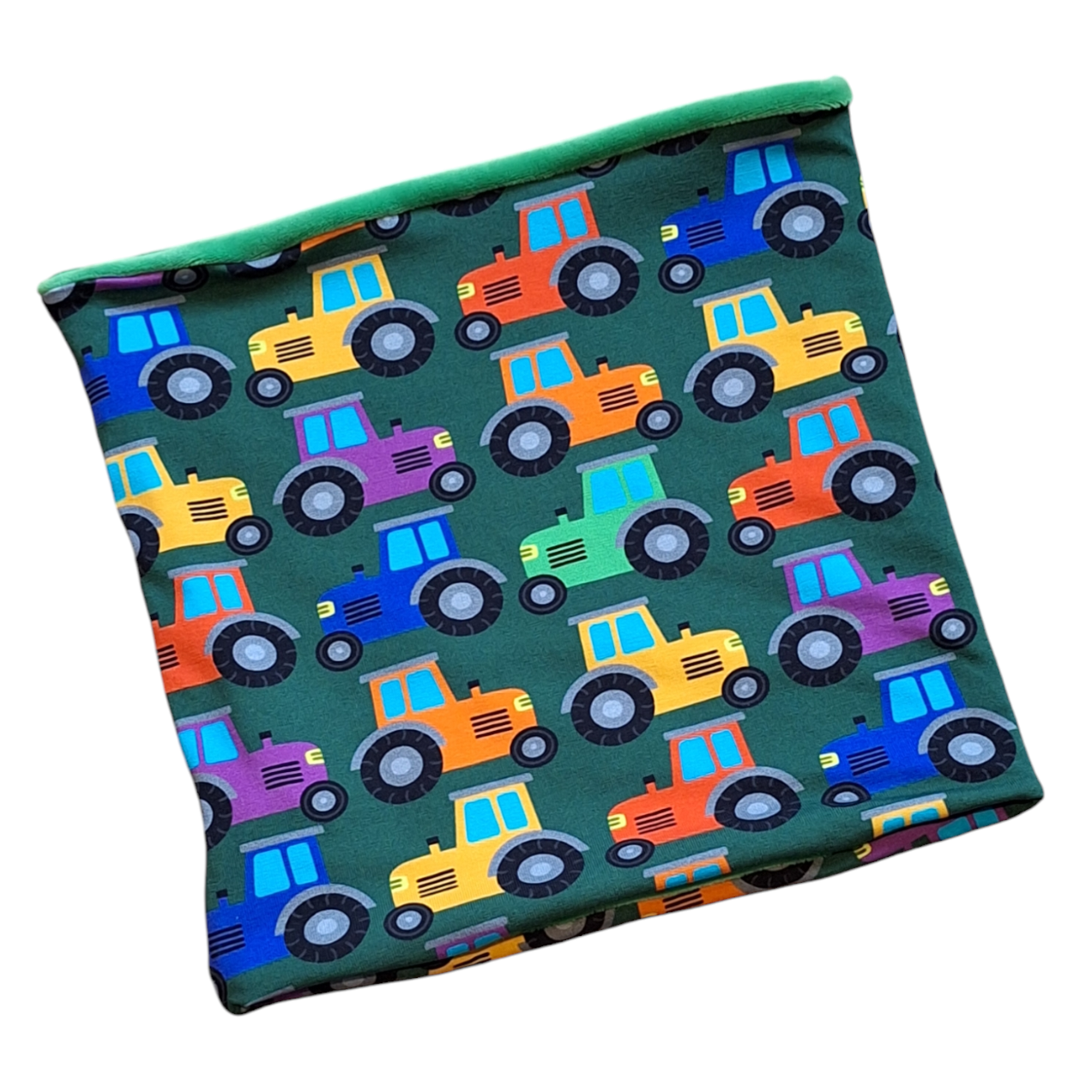 A hooded snood with a tractor pattern on a green background, reversible with a solid green on the other side.
