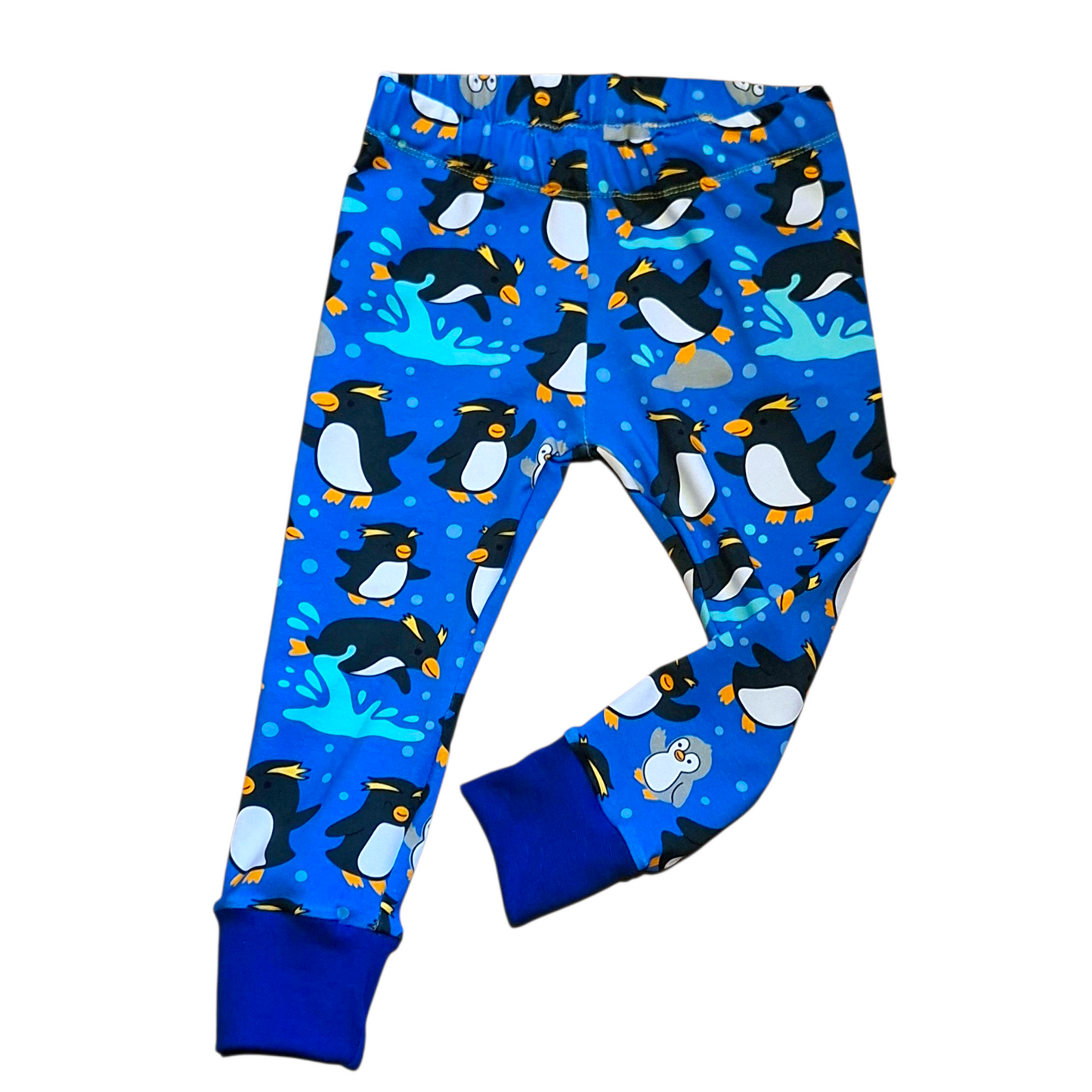 Blue children's leggings with penguin pattern on a white background