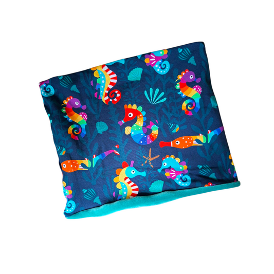 Colorful seahorse patterned fabric on a white background
