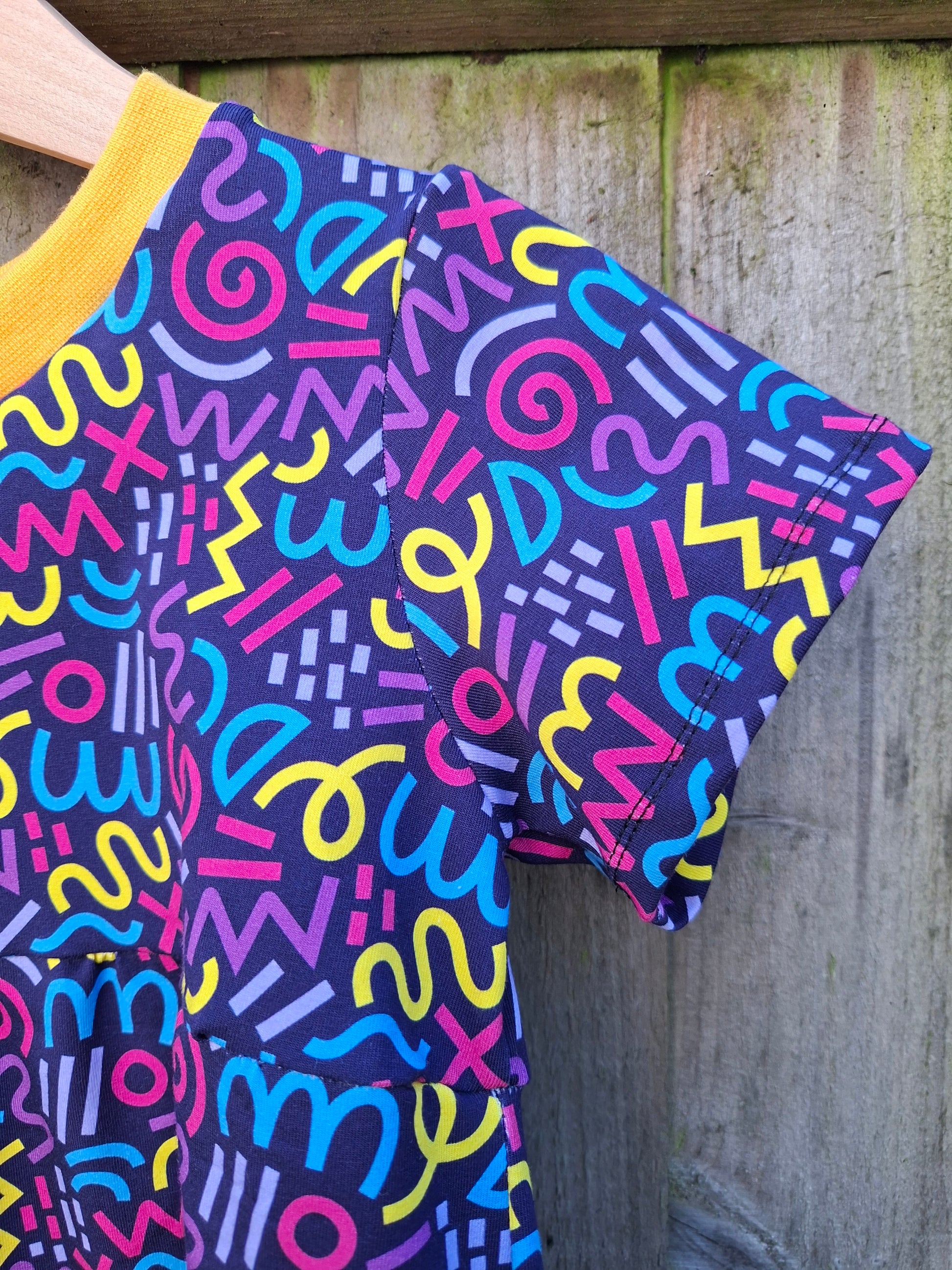 Colorful patterned fabric with abstract designs on a wooden surface