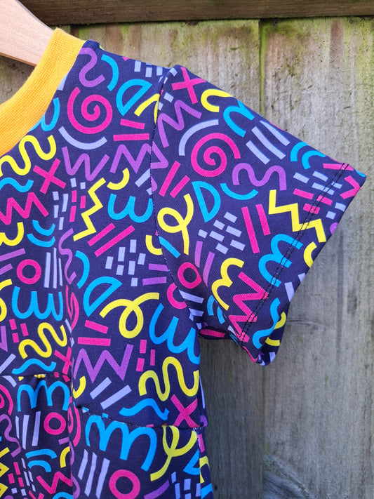 Colorful patterned fabric with abstract designs on a wooden surface
