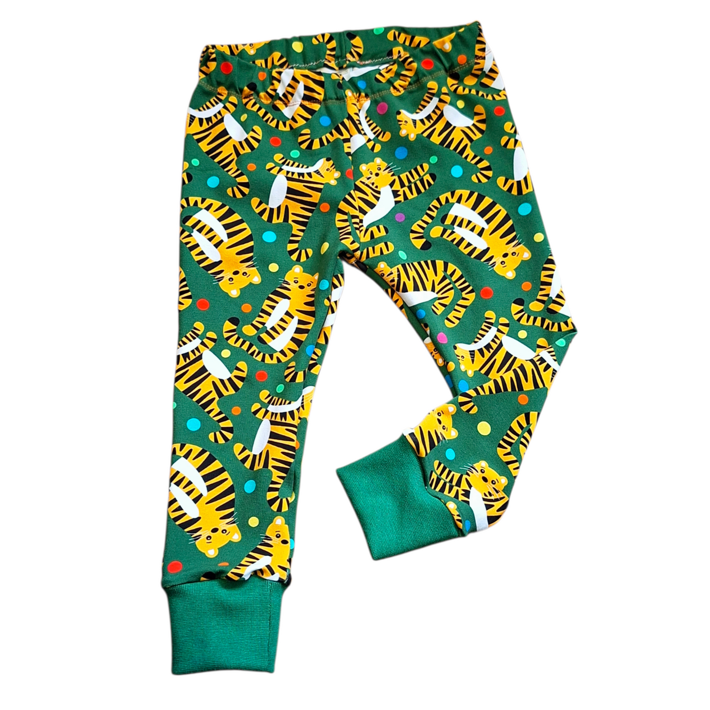 Colorful tiger-patterned pants on a green background