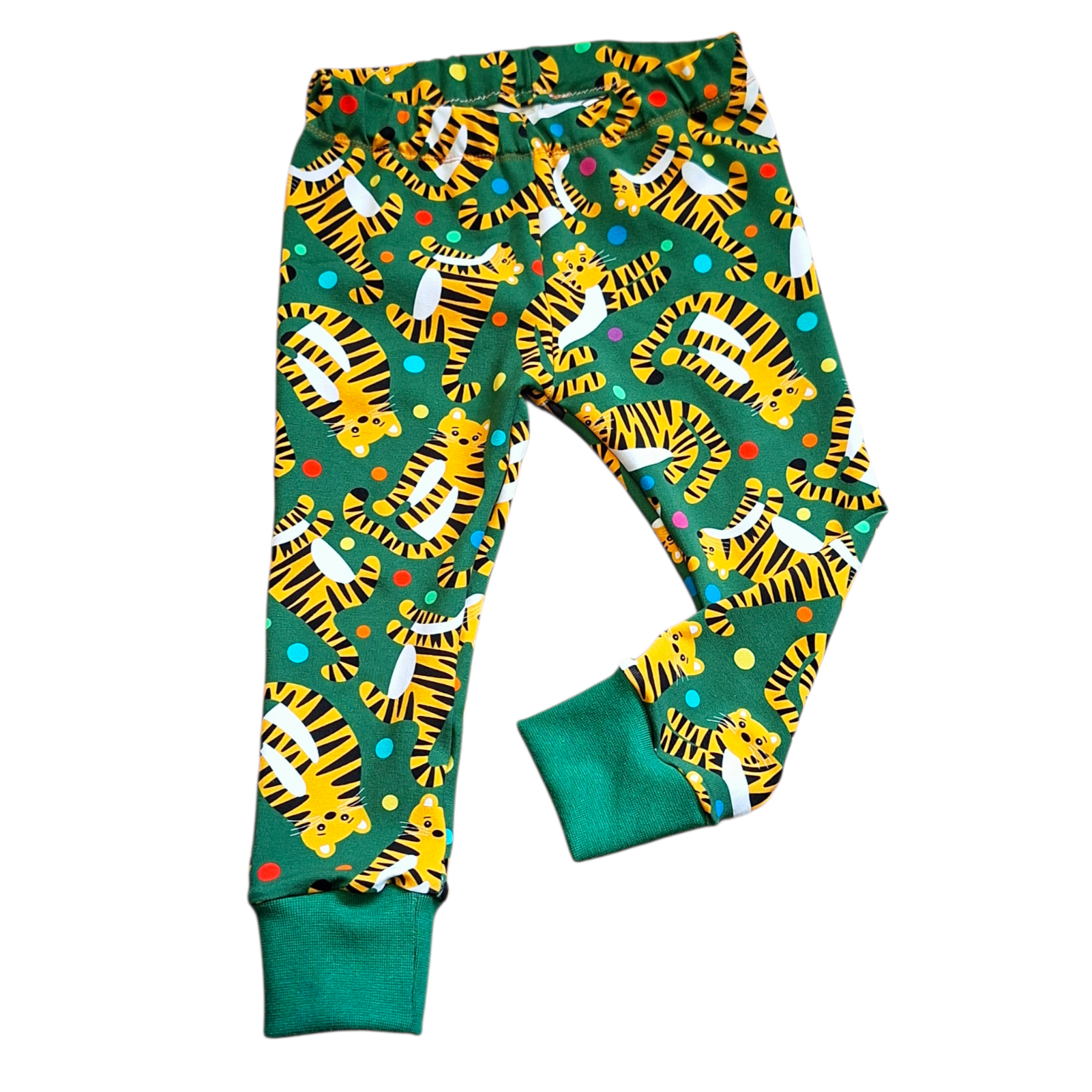 Colorful tiger-patterned pants on a green background
