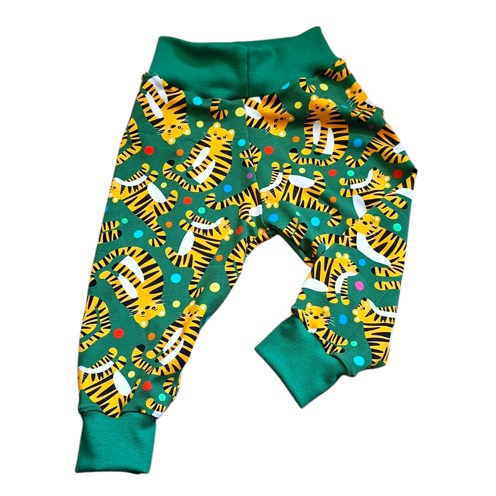 Children's trousers with tiger pattern on a green background