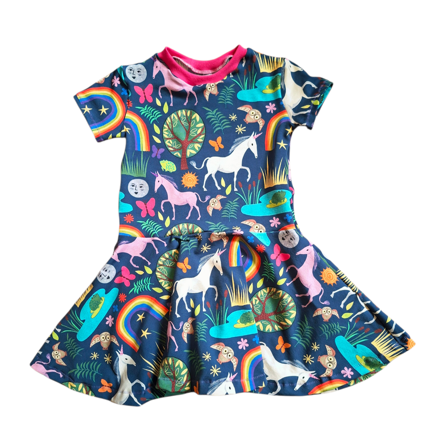 Colorful children's dress with unicorn and rainbow pattern on a white background
