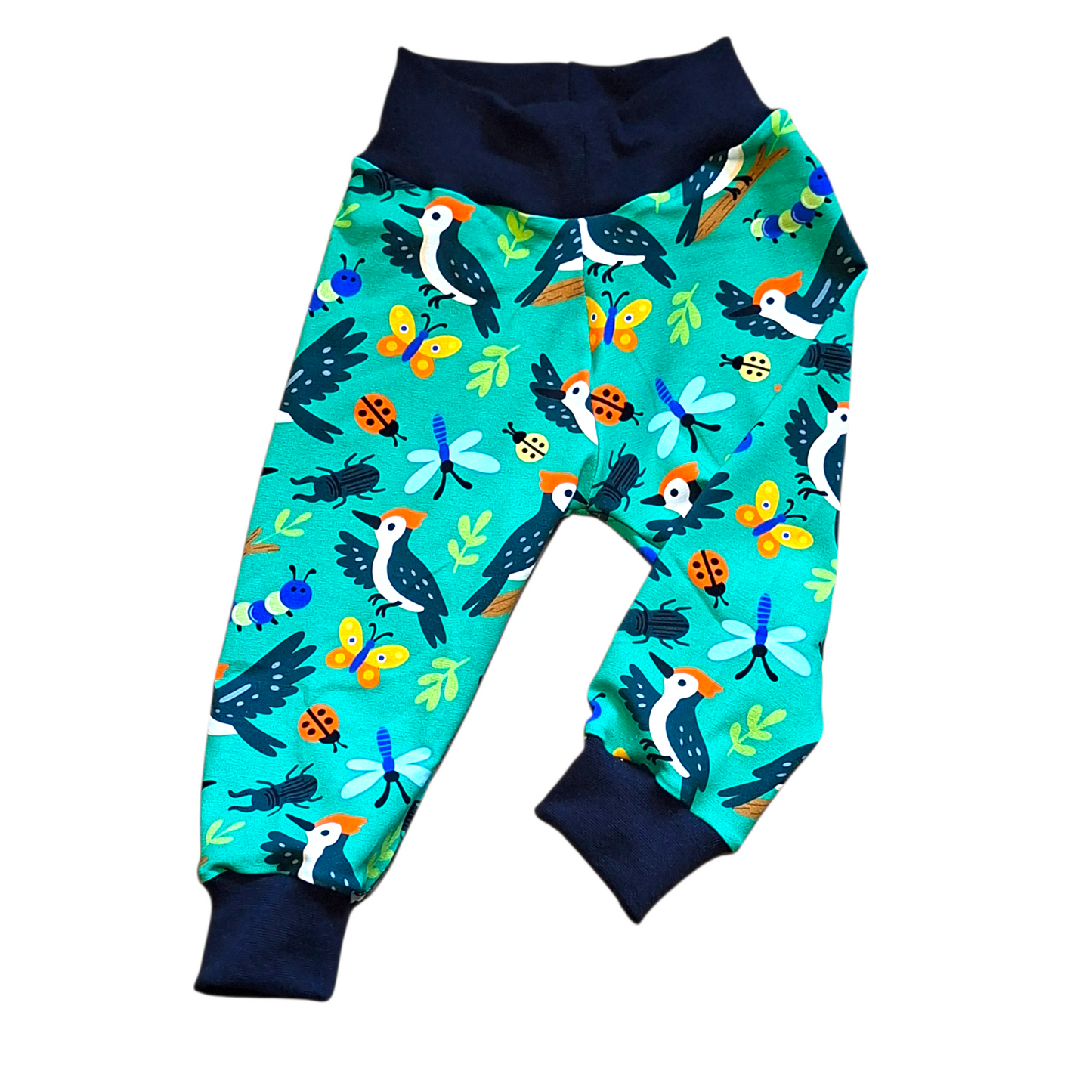 Colorful children's pants with bird and nature pattern on a white background