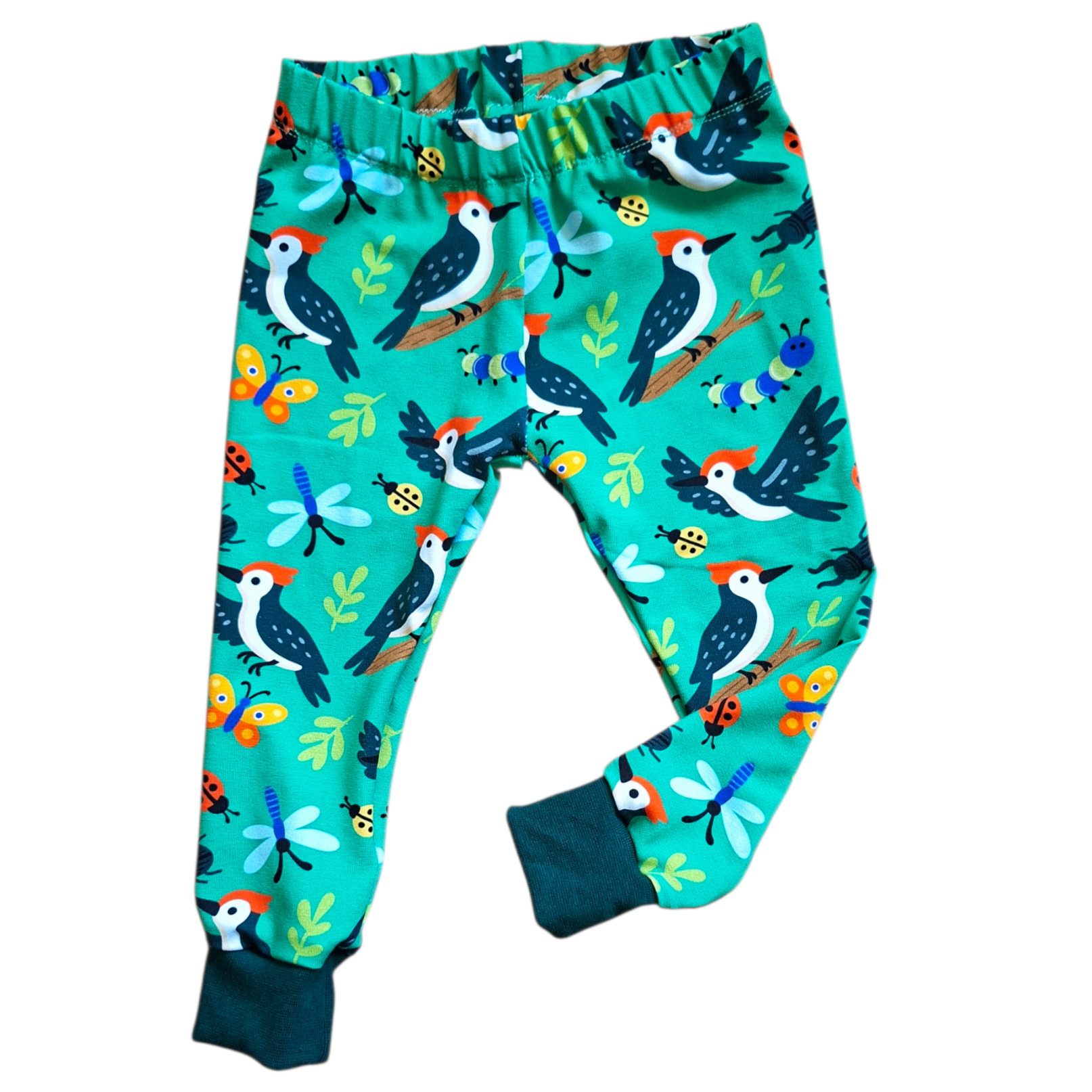 Children's pants with bird and nature pattern on a white background