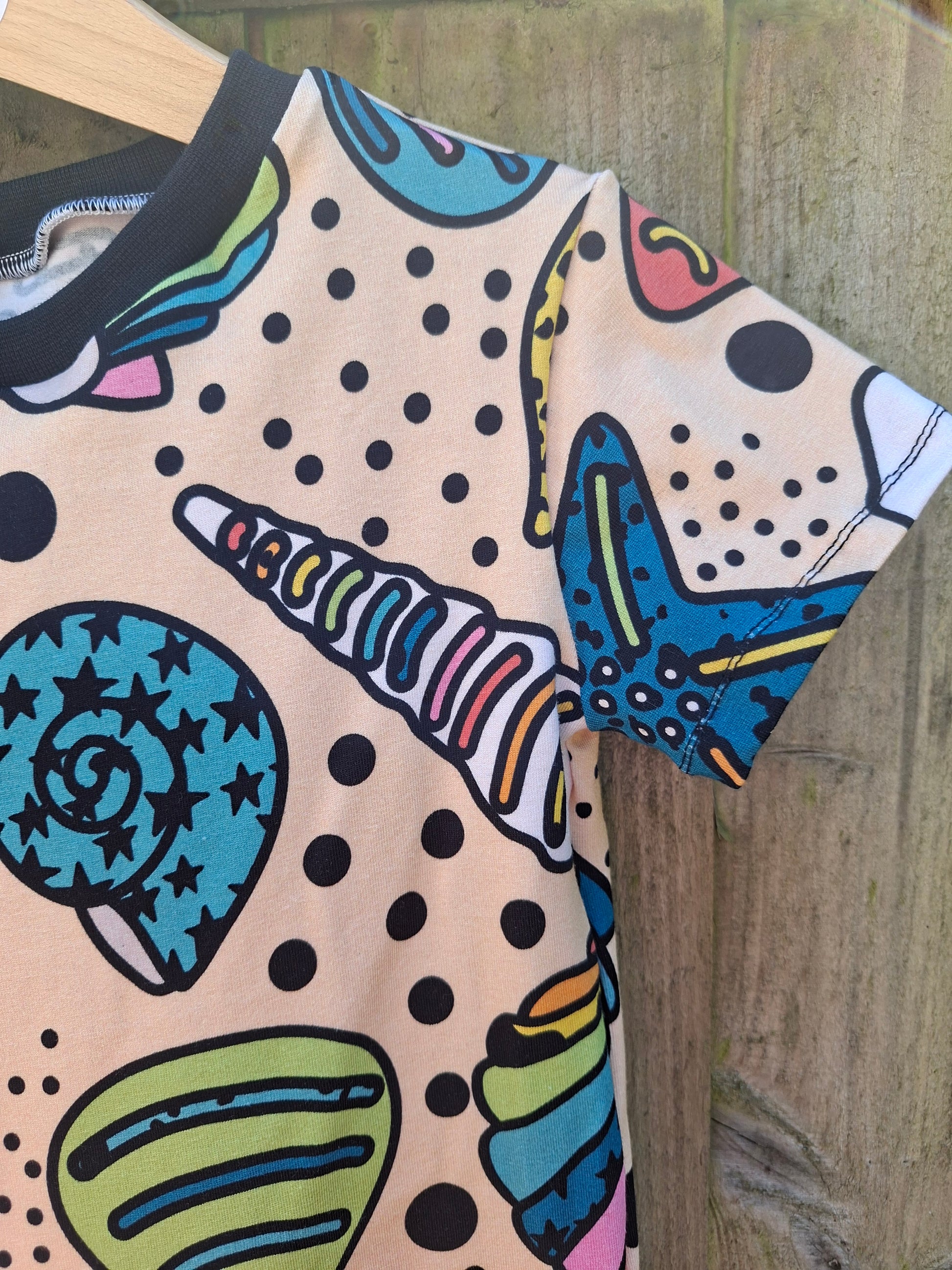 Children's seashell dress in a pastel rainbow design 