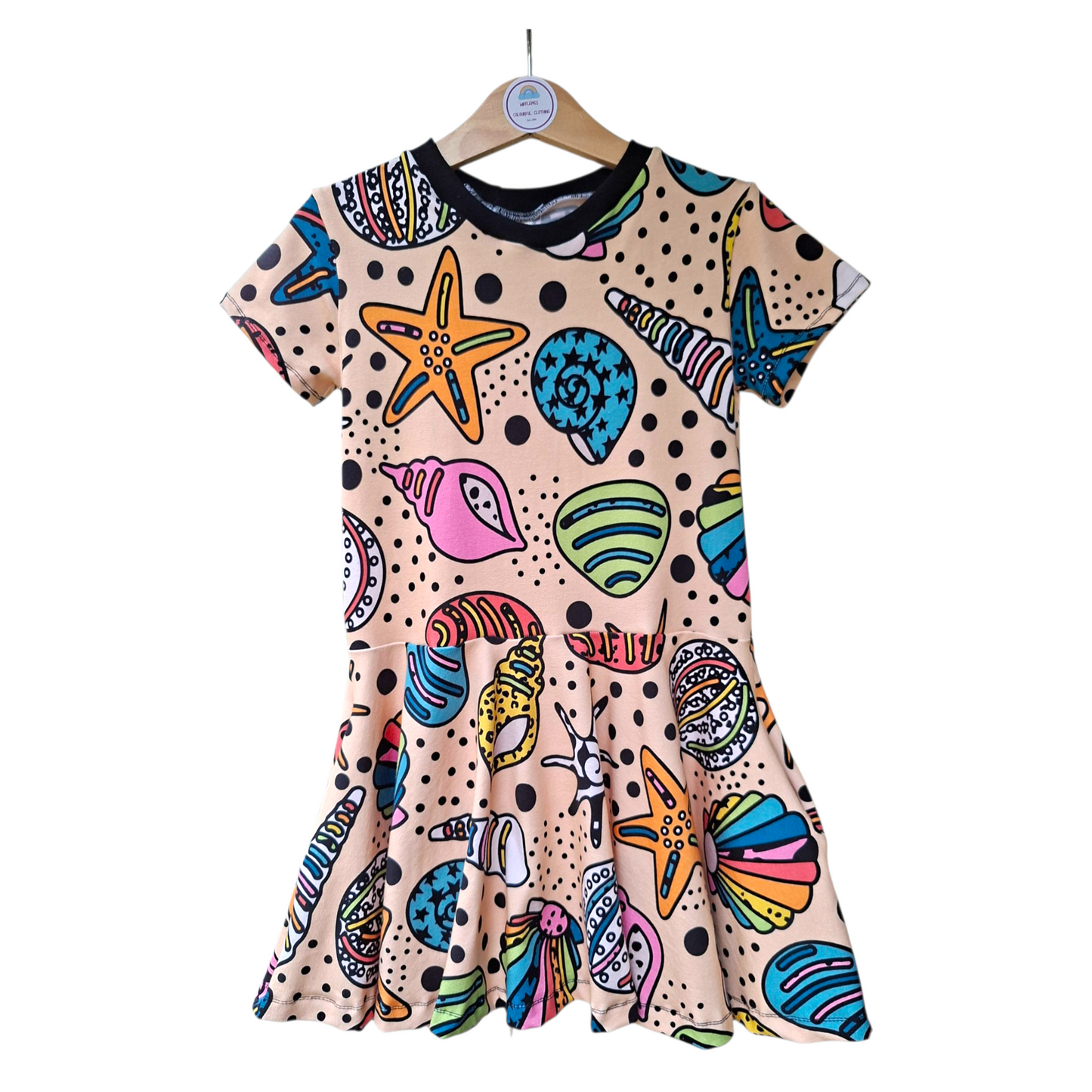 Children's twirly dress with pockets in a rainbow mix of sea shells 