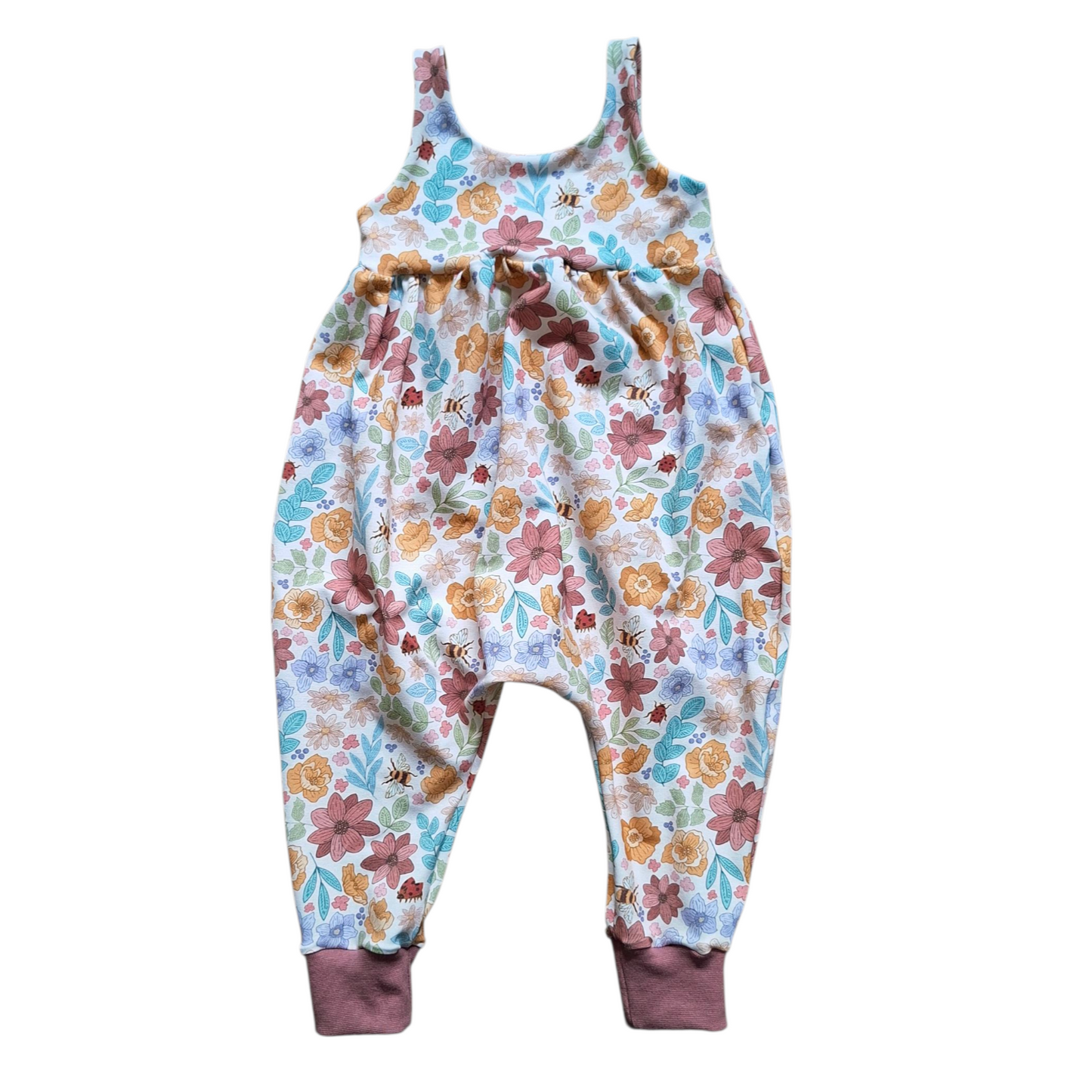 Children's gathered waist romper in a pastel floral design 