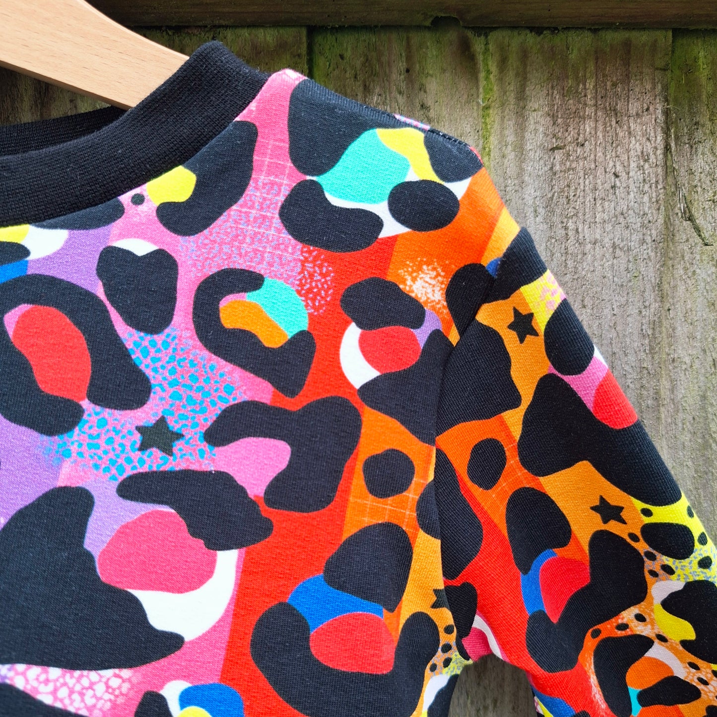 Children's jumper in a rainbow leopard print design 