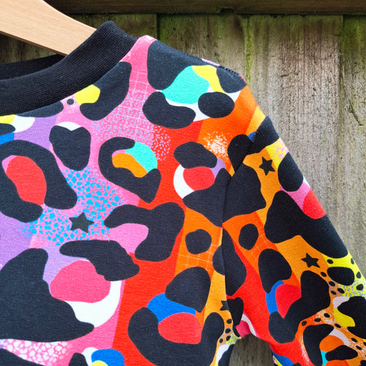 Children's jumper in a rainbow leopard print design 